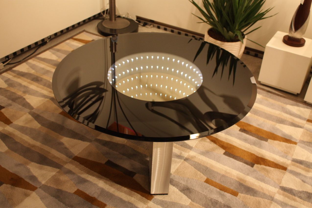 Nova's modern coffee table uses lights and reflection to call attention.