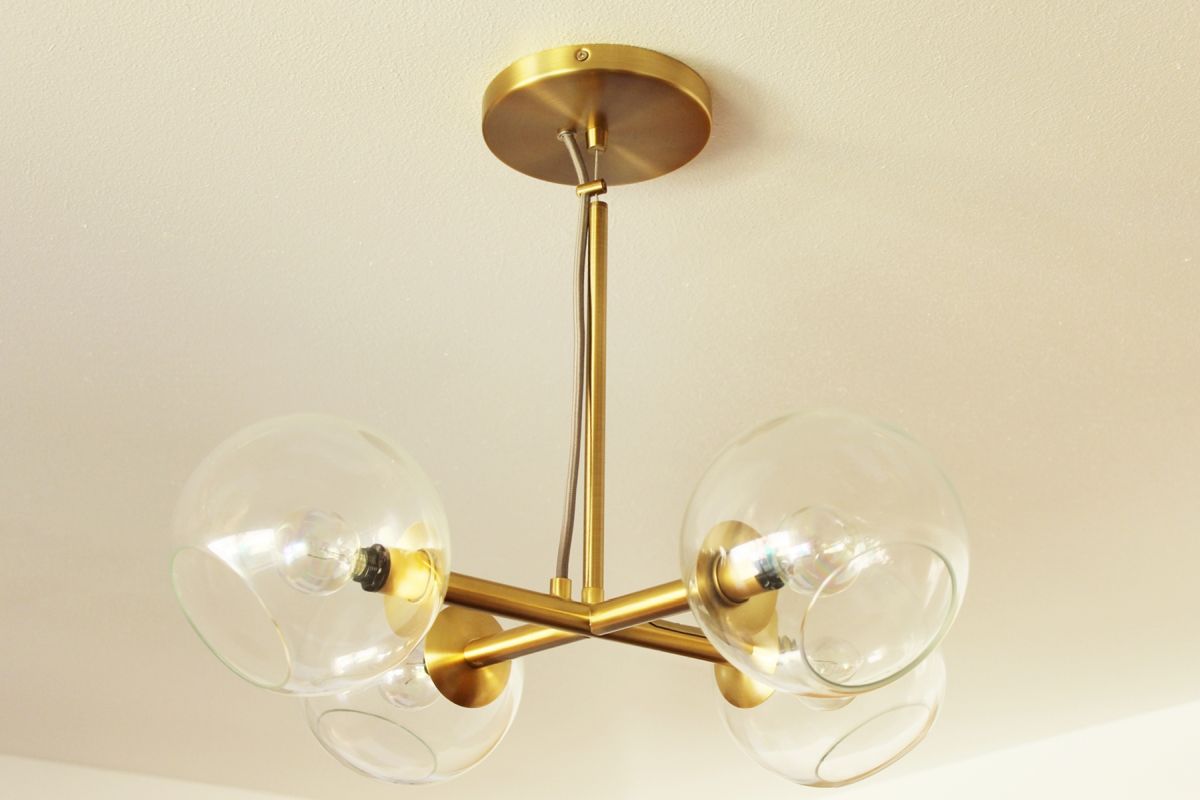 The bedroom’s main lighting brass